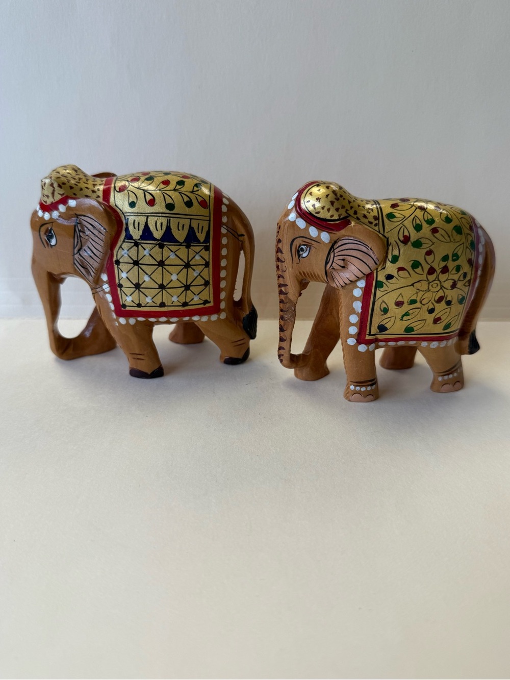 Pair of Vintage Hand-Painted Gold, Red and Black Carved Wood Elephant Figurines.